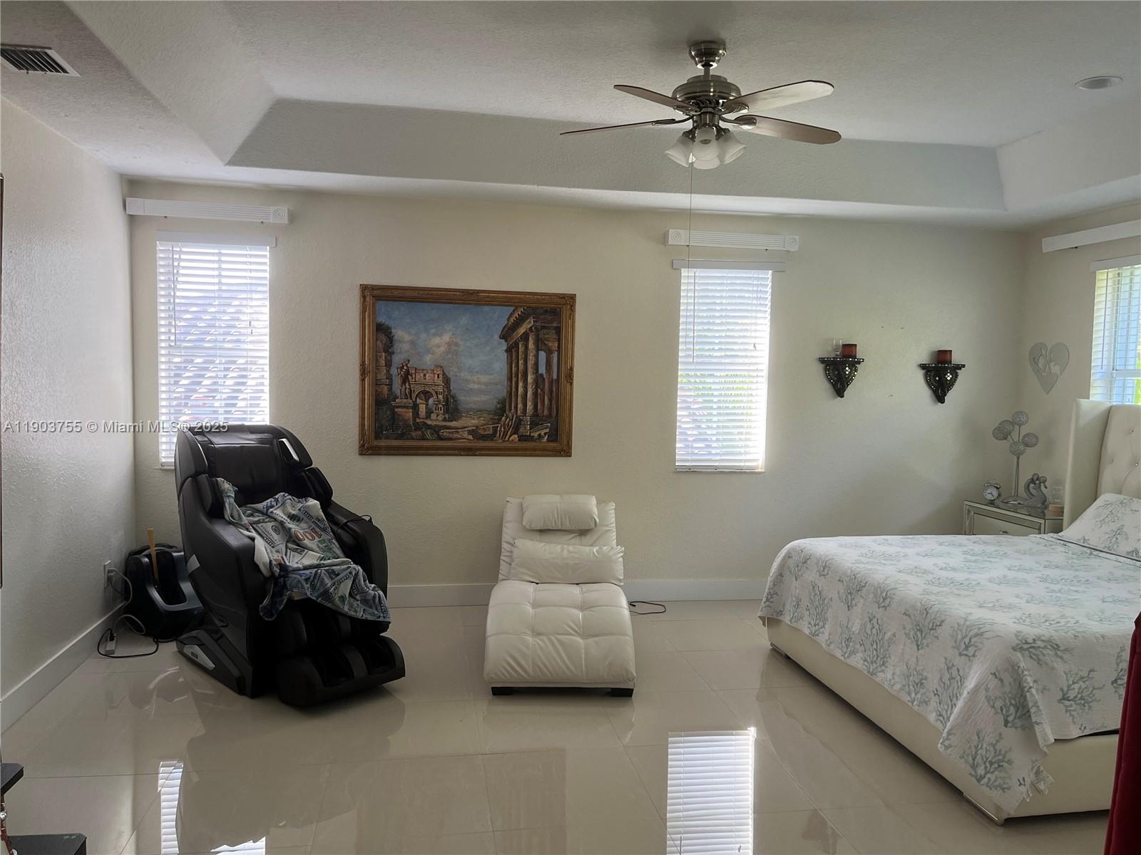 16801 Southwest 38th Street Miramar, FL 33027 - Photo 44 of 63 a bedroom with bed and a couch