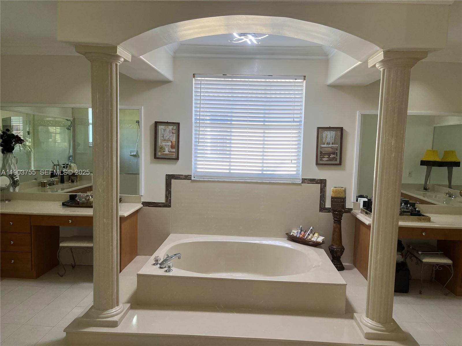 16801 Southwest 38th Street Miramar, FL 33027 - Photo 48 of 63 a bath tub sitting in a bathroom next to a bathroom sink