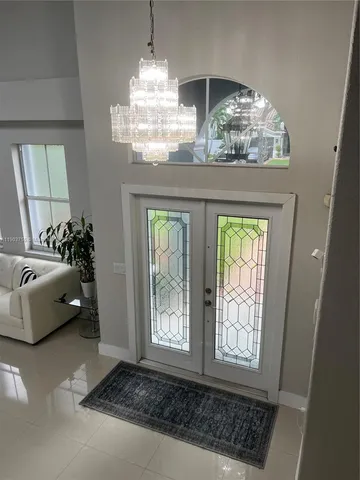 a bedroom with furniture and a chandelier