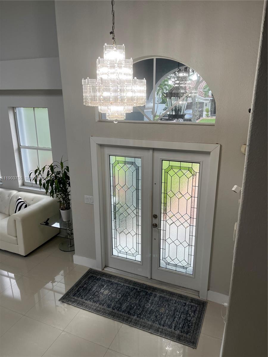 16801 Southwest 38th Street Miramar, FL 33027 - Photo 6 of 63 a living room with furniture and a chandelier