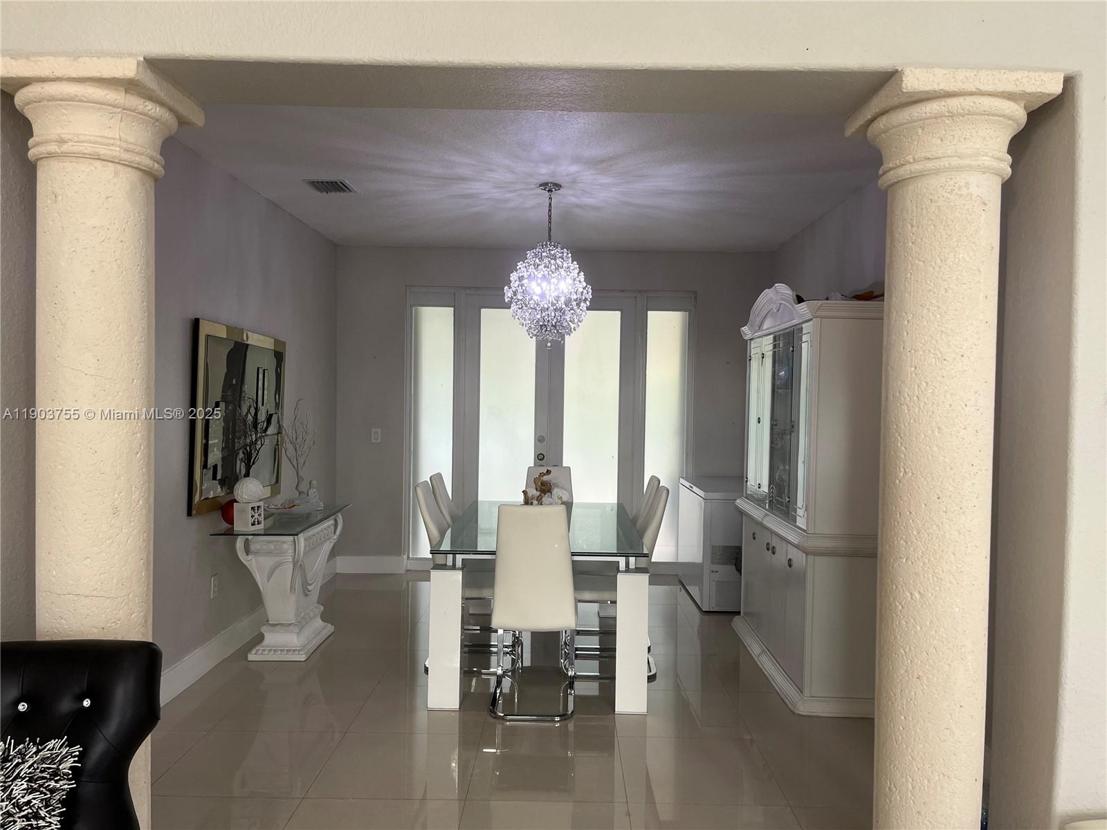 16801 Southwest 38th Street Miramar, FL 33027 - Photo 9 of 63 a view of a dining room with furniture window and wooden floor