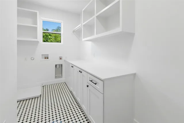 a view of a hallway with a white cabinet and a window