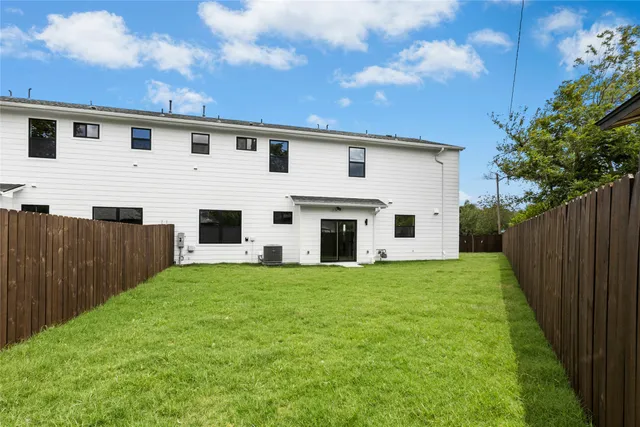 a view of a hallway with a white cabinet and a window