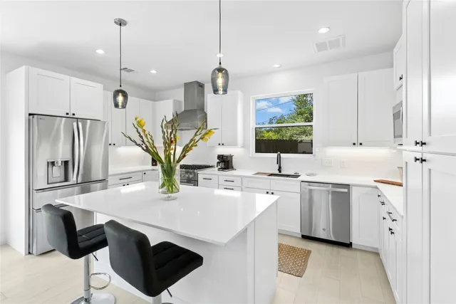 a kitchen with stainless steel appliances granite countertop a sink a counter space and cabinets