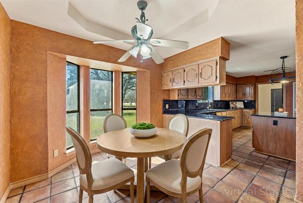 241 Simmons Road Double Oak, TX 75077 - Photo 13 of 40 Dining space featuring a textured wall, a ceiling fan, and a raised ceiling