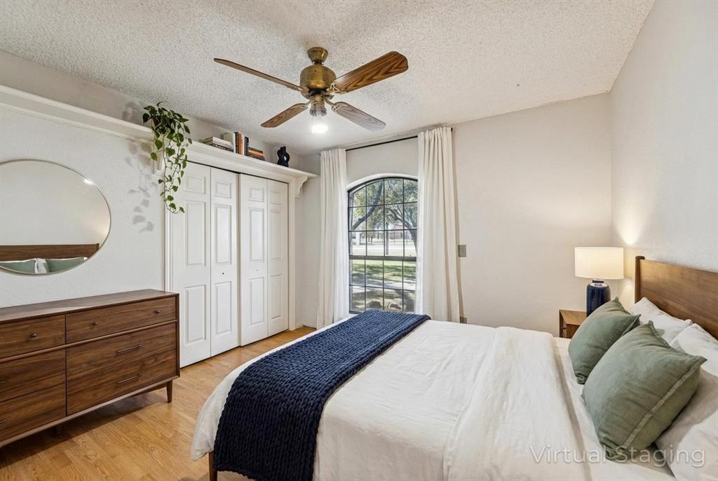 241 Simmons Road Double Oak, TX 75077 - Photo 17 of 40 Bedroom with light wood finished floors, ceiling fan, a textured ceiling, and a closet