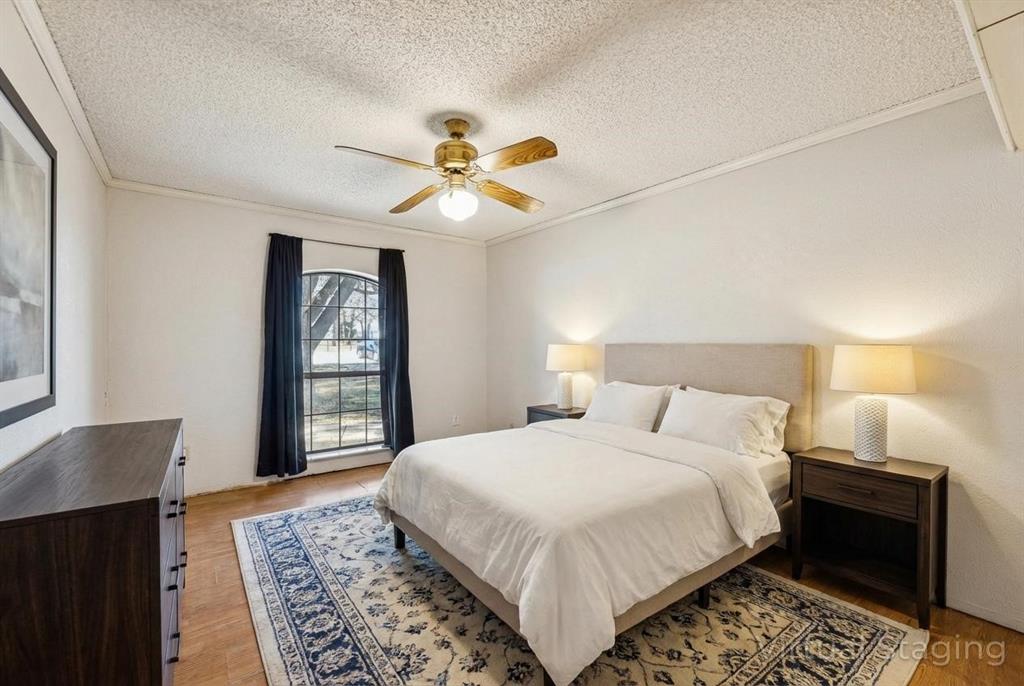241 Simmons Road Double Oak, TX 75077 - Photo 20 of 40 Bedroom featuring a ceiling fan, a textured ceiling, ornamental molding, and light wood-style floors