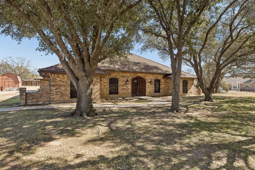 241 Simmons Road Double Oak, TX 75077 - Photo 2 of 40 View of front facade with brick siding and a front lawn