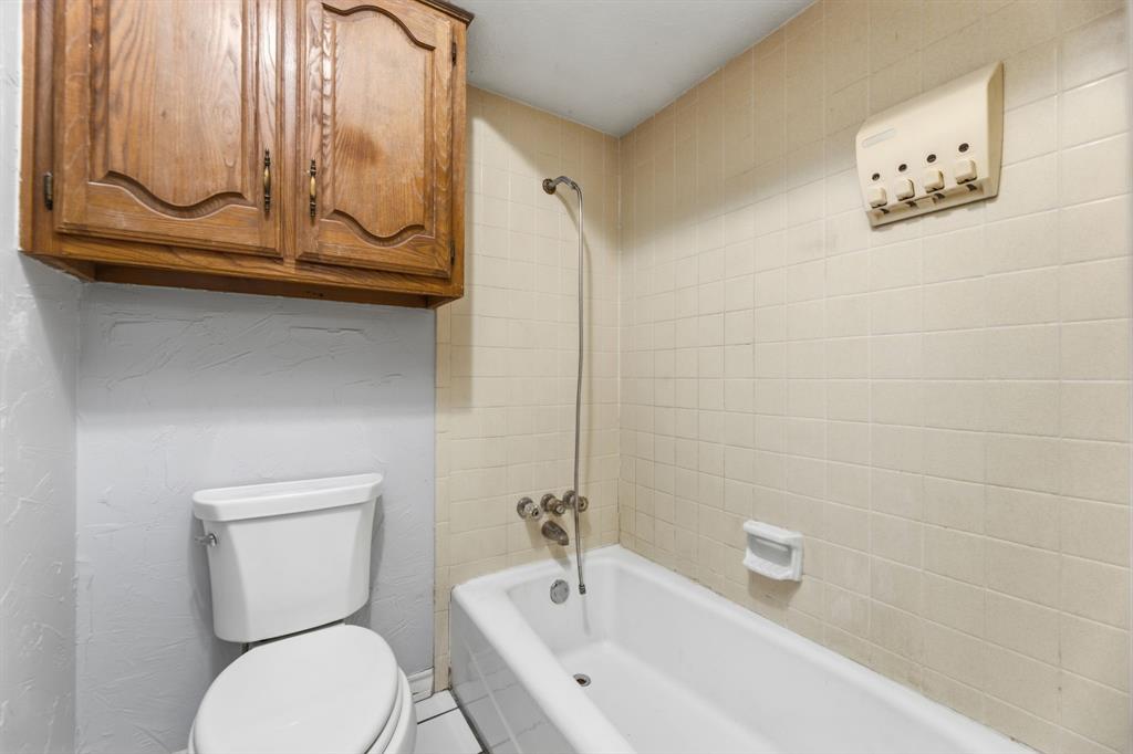 241 Simmons Road Double Oak, TX 75077 - Photo 22 of 40 Full bathroom featuring toilet and shower combination