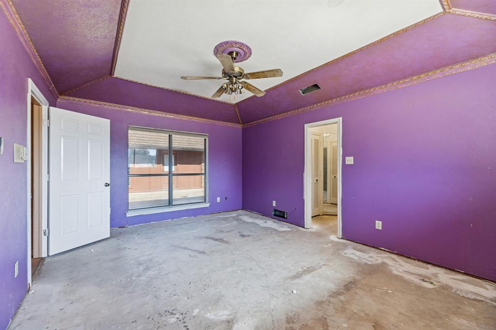 241 Simmons Road Double Oak, TX 75077 - Photo 25 of 40 Unfurnished bedroom featuring a raised ceiling, ceiling fan, and concrete flooring