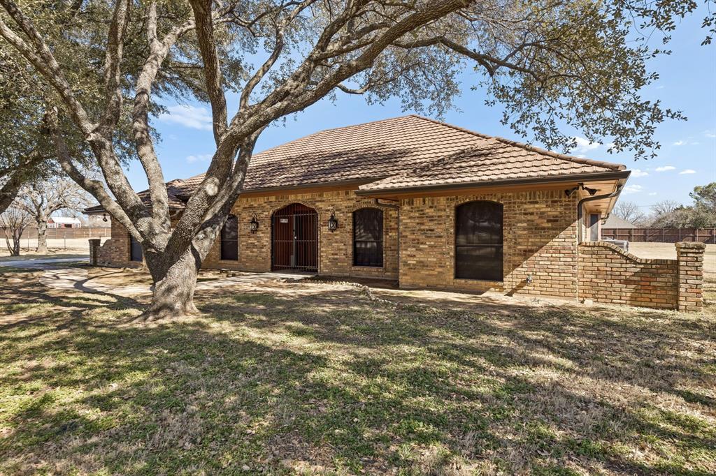 241 Simmons Road Double Oak, TX 75077 - Photo 3 of 40 View of front facade with brick siding and a tiled roof