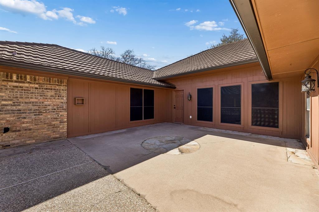 241 Simmons Road Double Oak, TX 75077 - Photo 36 of 40 Rear view of property featuring a patio, a tile roof, and brick siding