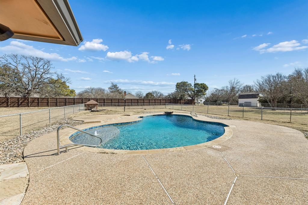 241 Simmons Road Double Oak, TX 75077 - Photo 37 of 40 View of pool featuring a fenced backyard and patio surround