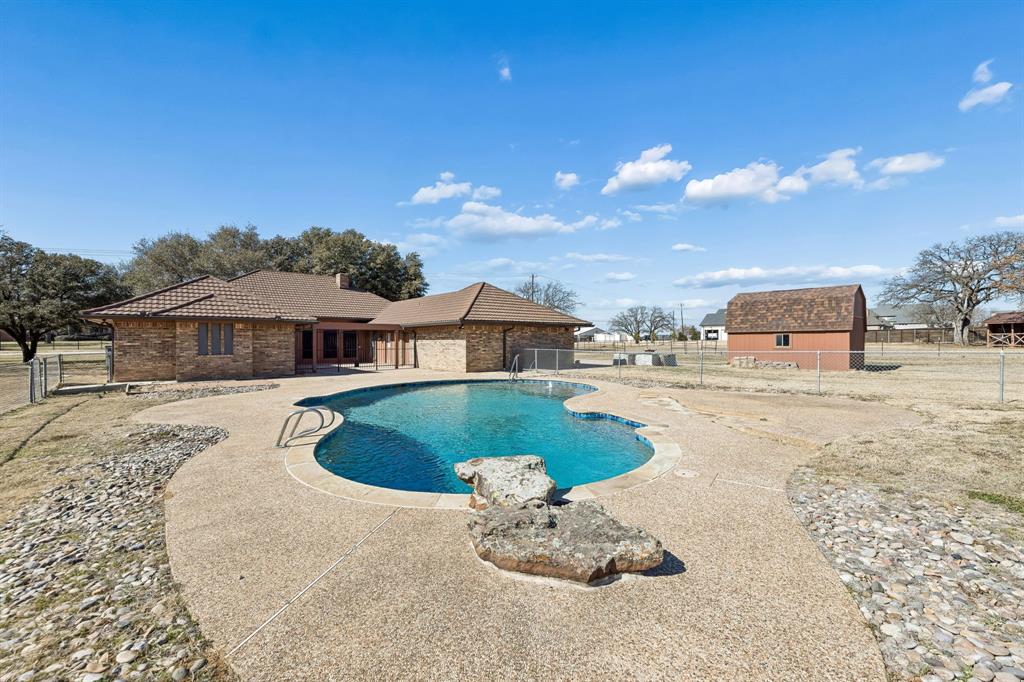 241 Simmons Road Double Oak, TX 75077 - Photo 39 of 40 View of swimming pool with patio surround and a fenced backyard
