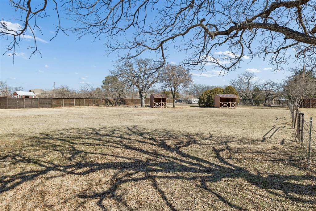 241 Simmons Road Double Oak, TX 75077 - Photo 40 of 40 View of yard featuring a storage unit