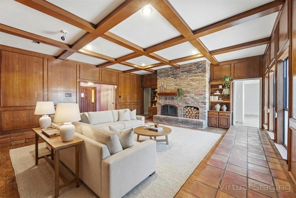 241 Simmons Road Double Oak, TX 75077 - Photo 8 of 40 Living room with wooden walls, coffered ceiling, a fireplace, and built in features