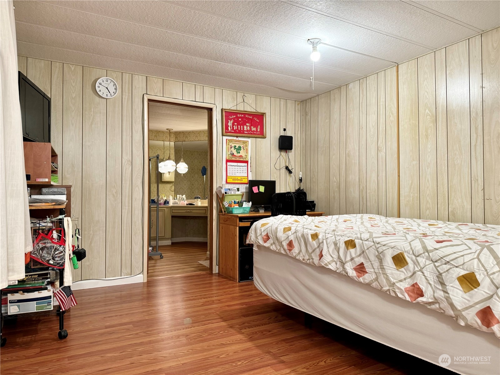 201 Union Avenue Southeast, Unit 142 Renton, WA 98059 - Photo 17 of 20 a bedroom with a bed and wooden floor