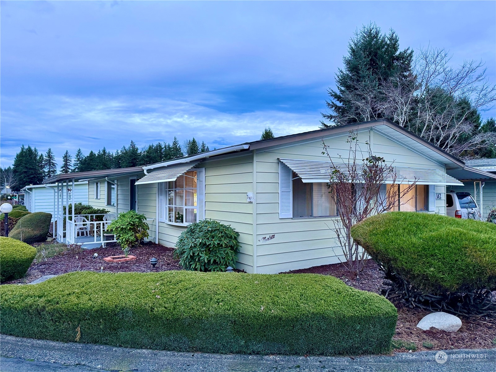 201 Union Avenue Southeast, Unit 142 Renton, WA 98059 - Photo 3 of 20 a front view of a house with garden