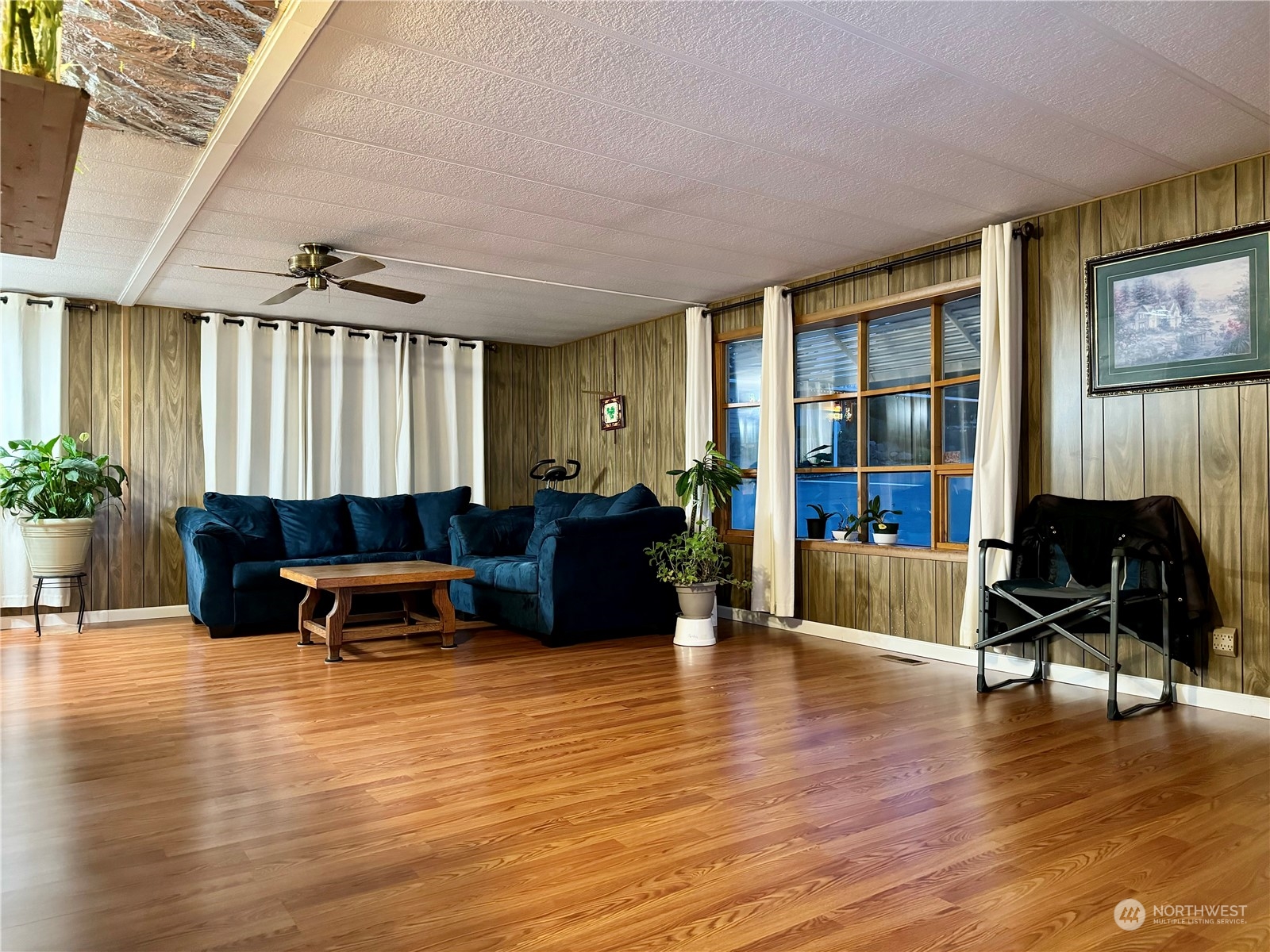 201 Union Avenue Southeast, Unit 142 Renton, WA 98059 - Photo 9 of 20 a living room with furniture a fireplace and a large window