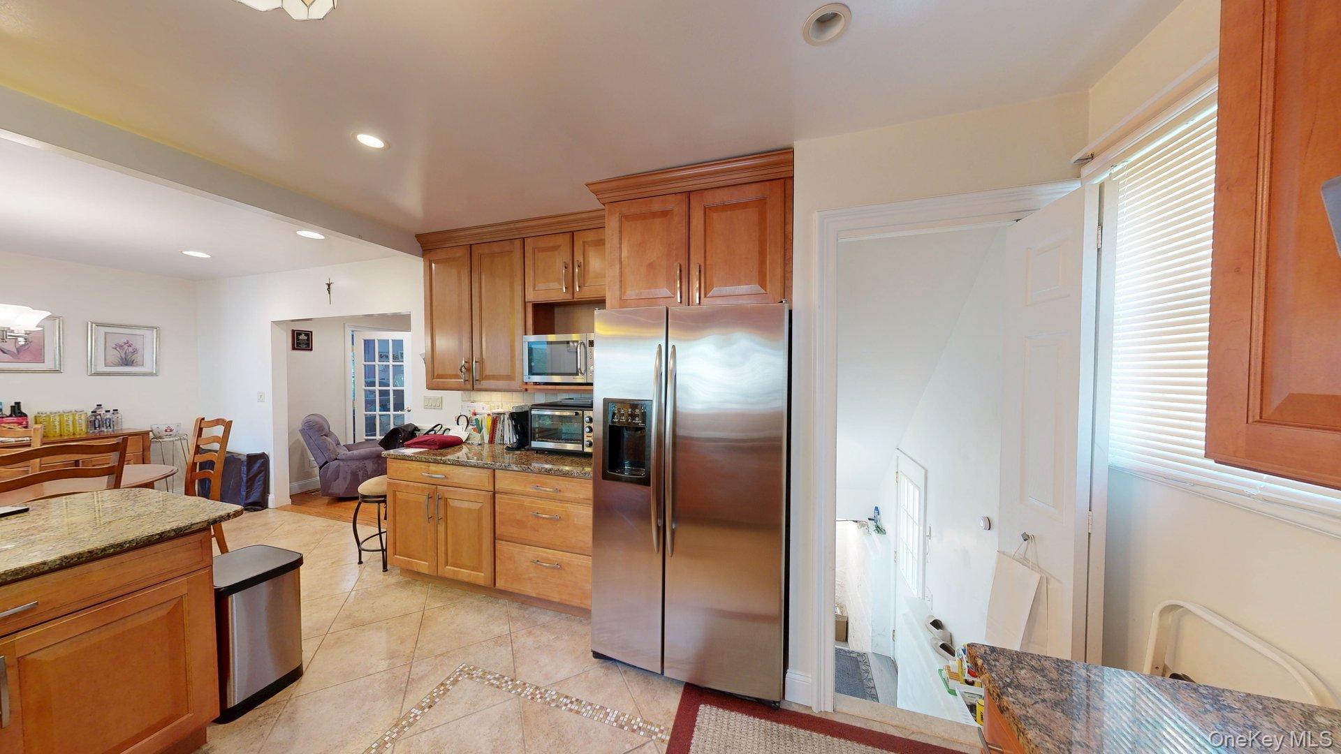 15 Woodbine Road Irvington, NY 10533 - Photo 11 of 20 a kitchen with stainless steel appliances granite countertop a refrigerator and a stove top oven