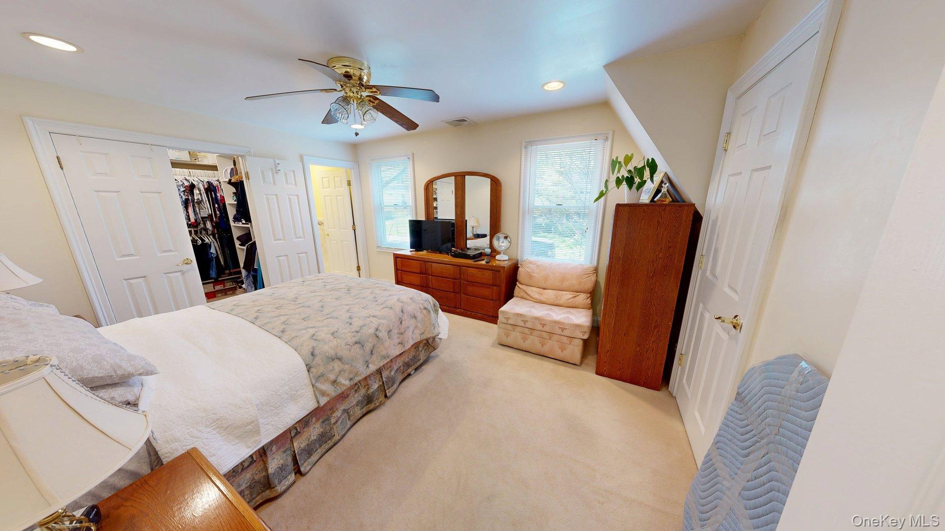 15 Woodbine Road Irvington, NY 10533 - Photo 15 of 20 a bedroom with a large bed and a large mirror