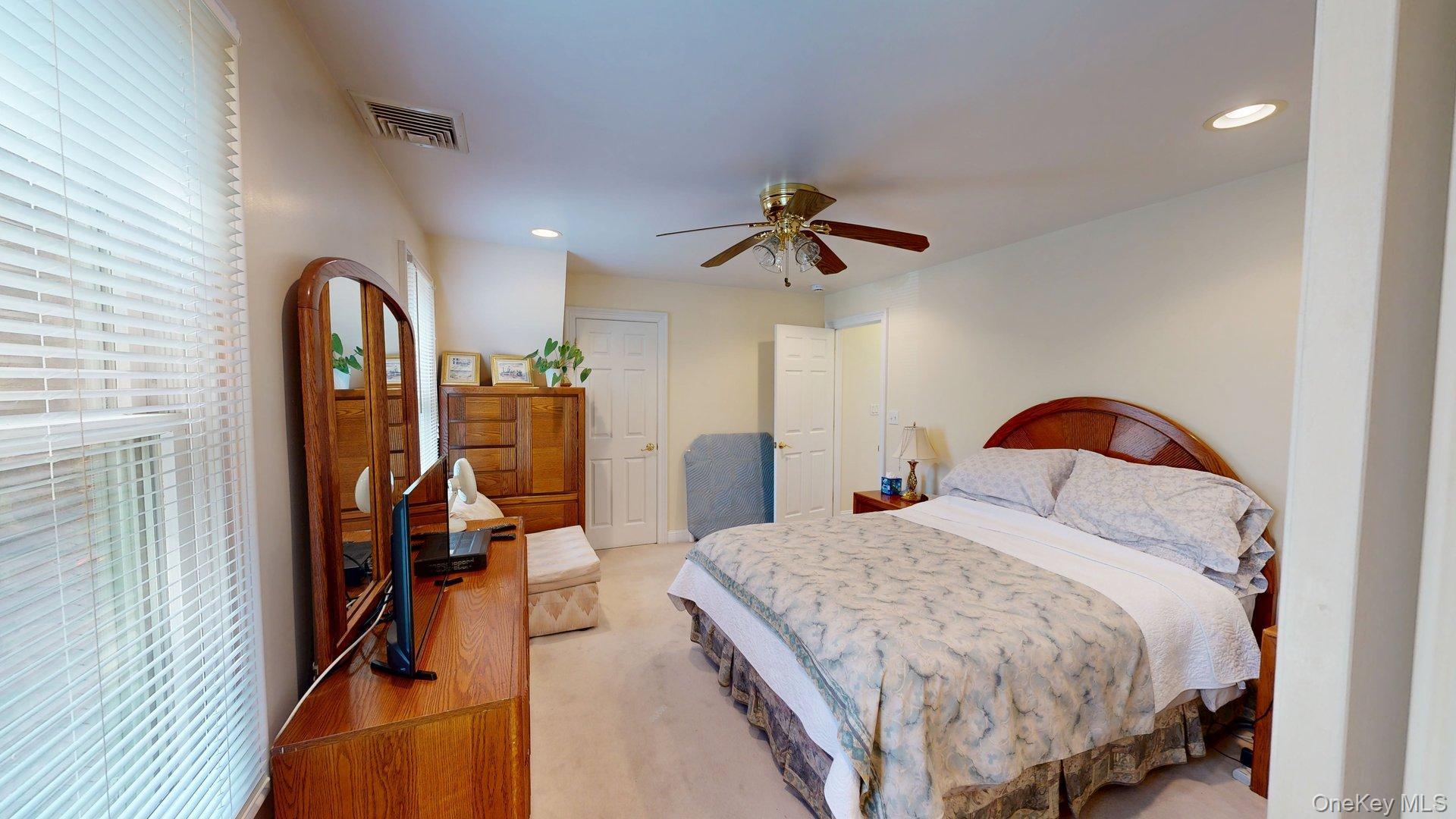 15 Woodbine Road Irvington, NY 10533 - Photo 16 of 20 a bedroom with a large bed and a chandelier