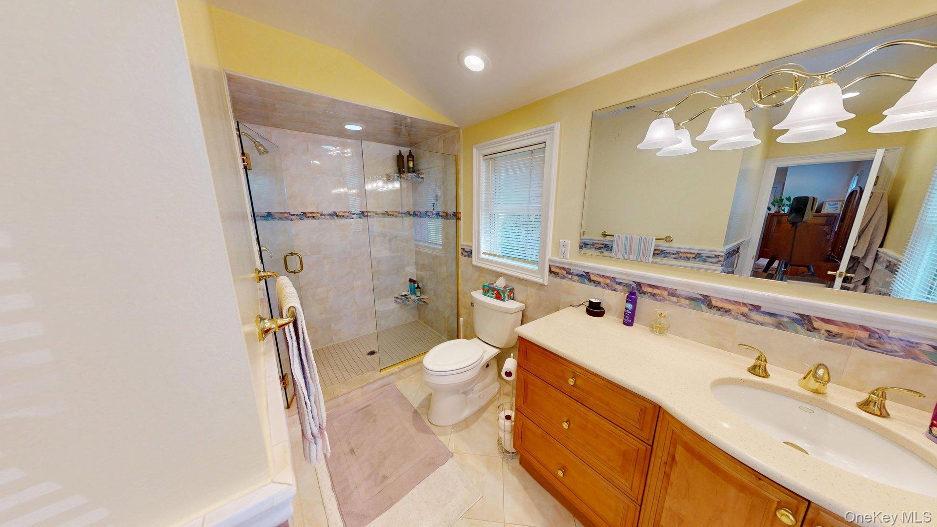 15 Woodbine Road Irvington, NY 10533 - Photo 18 of 20 a bathroom with a sink a toilet a mirror and shower