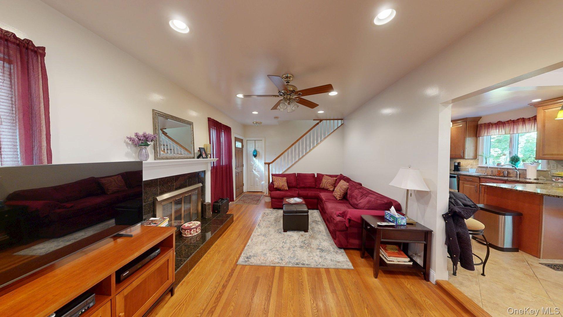 15 Woodbine Road Irvington, NY 10533 - Photo 2 of 20 a living room with furniture a fireplace and a flat screen tv