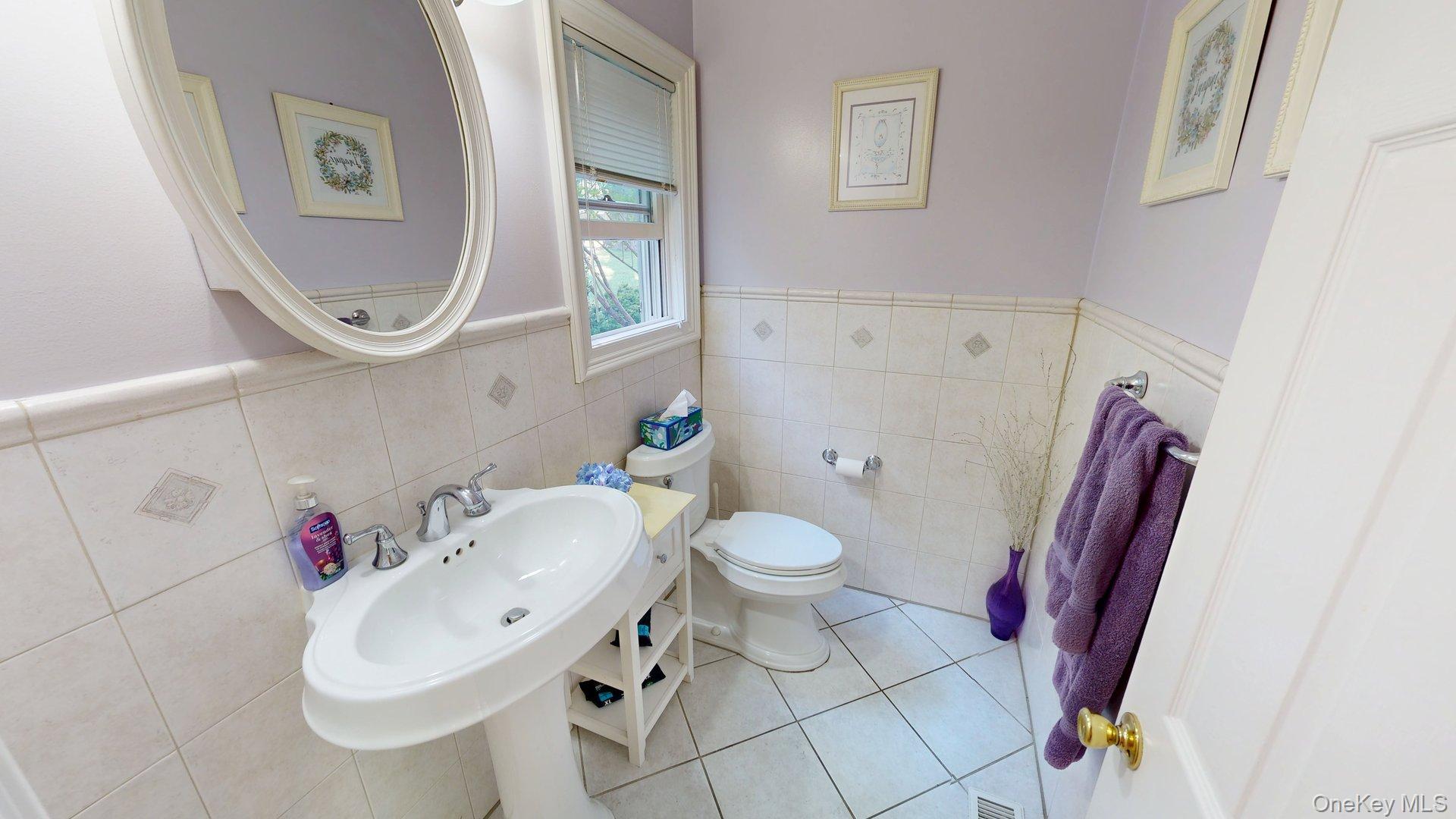 15 Woodbine Road Irvington, NY 10533 - Photo 6 of 20 a bathroom with a sink mirror and toilet