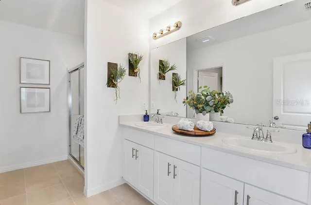 a bathroom with a shower and a sink
