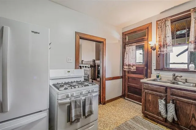 a kitchen with stainless steel appliances granite countertop a stove and a refrigerator