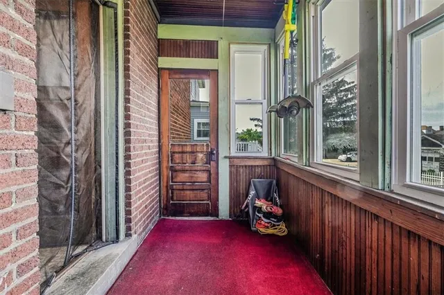 a view of a porch with a table and chairs