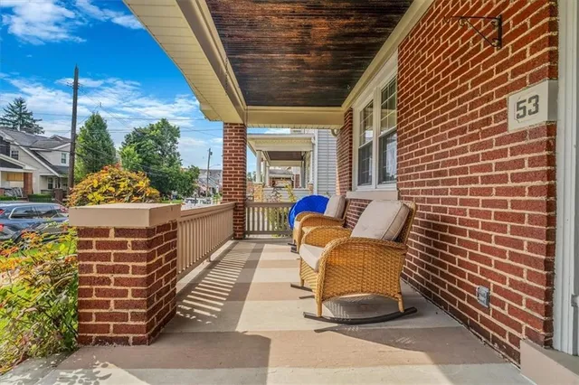 a view of a patio with a table and chairs and potted plants