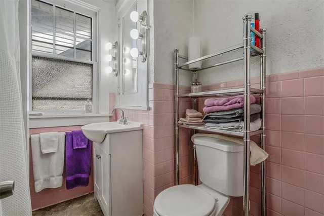 a bathroom with a granite countertop sink a mirror and shower