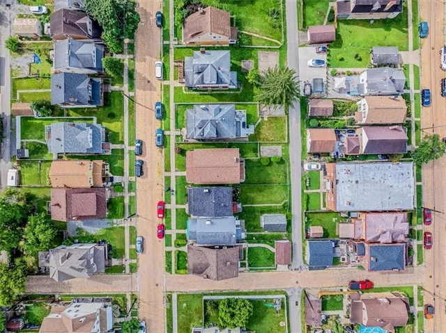 an aerial view of multiple houses with yard
