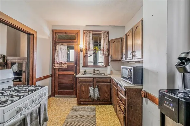 a kitchen with stainless steel appliances granite countertop a stove and a sink