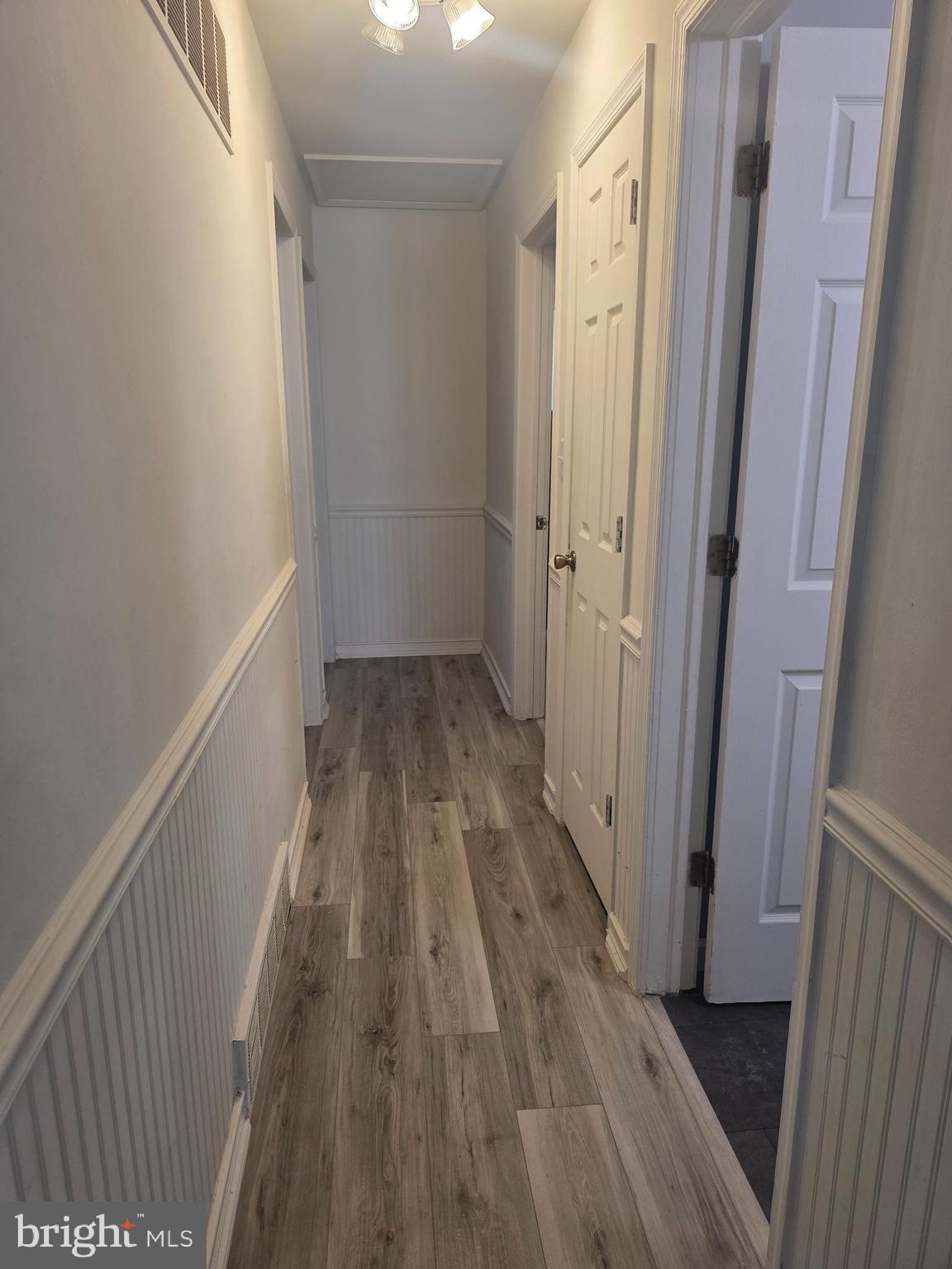 537 Centerton Road Pittsgrove, NJ 08318 - Photo 8 of 28 a view of a hallway with wooden floor and staircase
