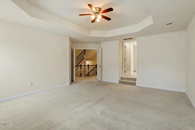 a spacious bathroom with a tub sink and mirror