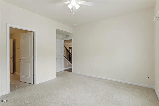 an empty room with a chandelier fan
