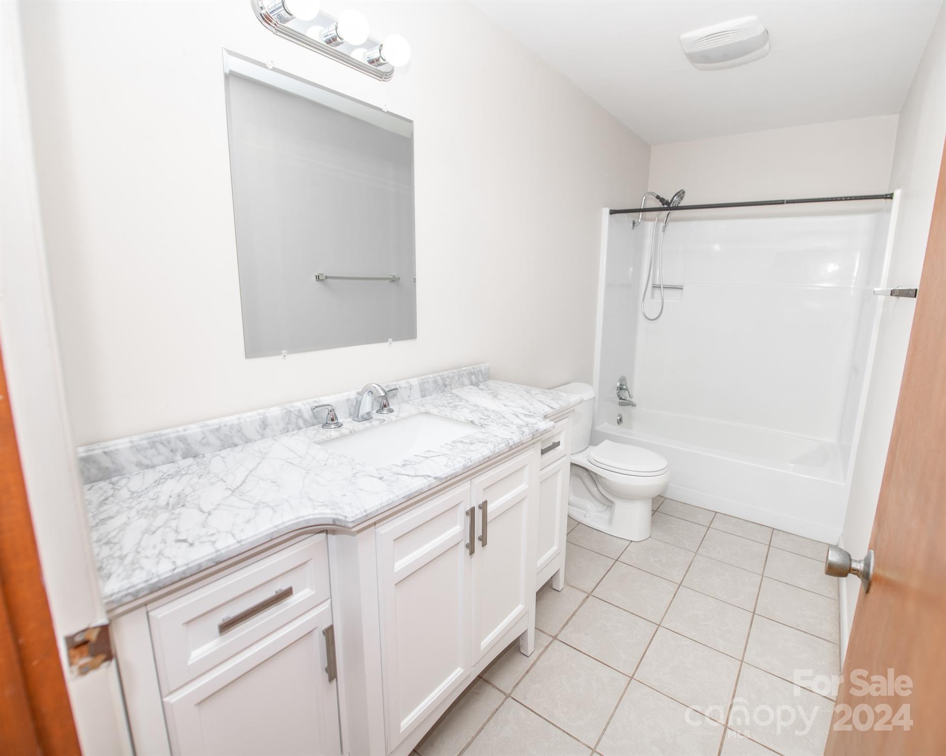 4000 Lake Shore Road South Denver, NC 28037 - Photo 38 of 46 a bathroom with a granite countertop sink a toilet and a mirror