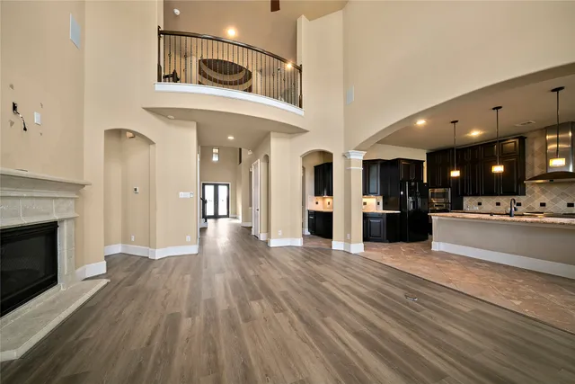 a large kitchen with kitchen island a large counter top stainless steel appliances and cabinets