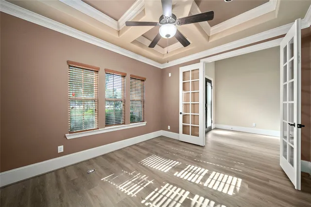 a view of a hallway with wooden floor and staircase