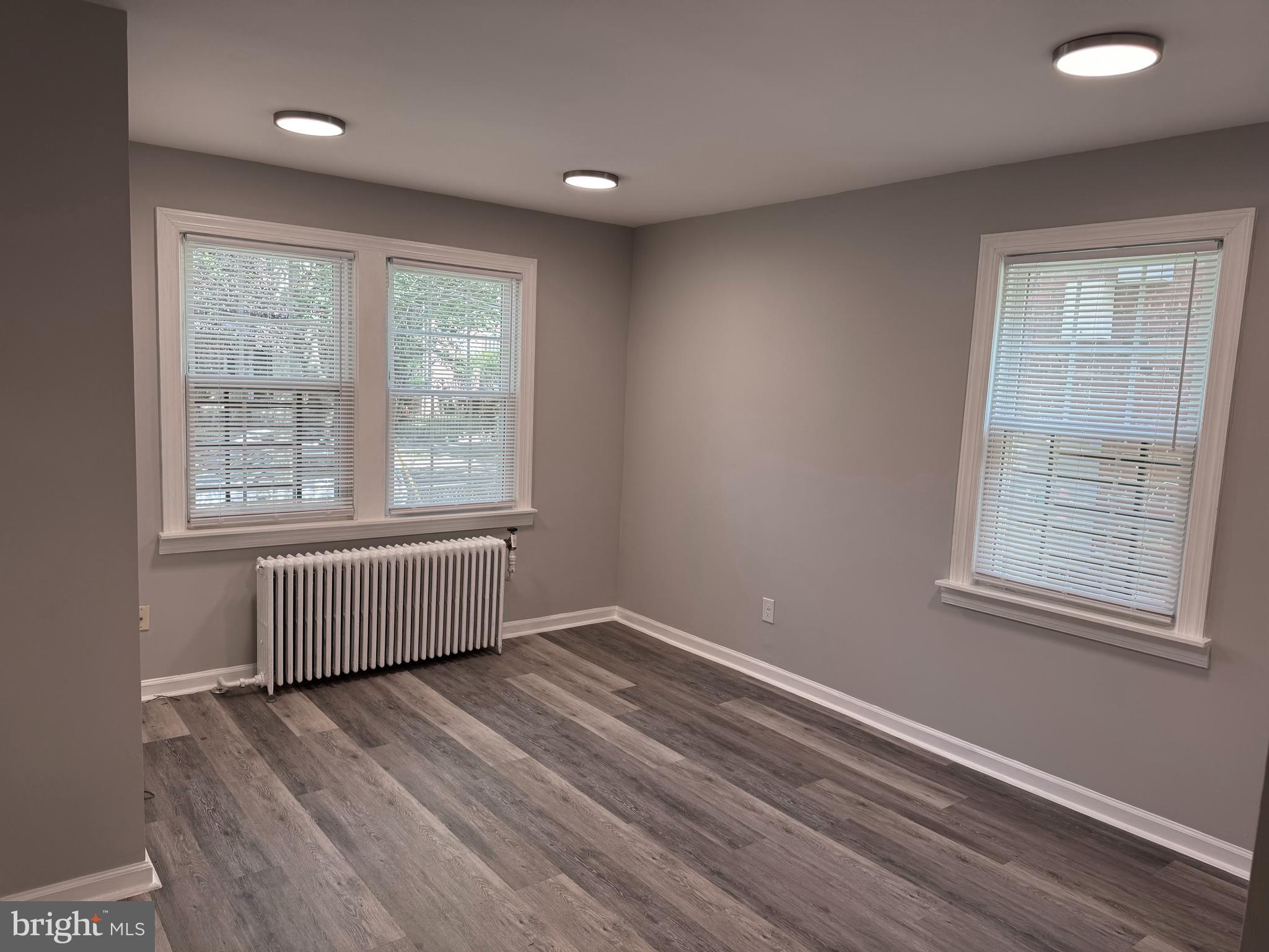 515 45th Street Northeast Washington, DC 20019 - Photo 2 of 11 an empty room with wooden floor and windows