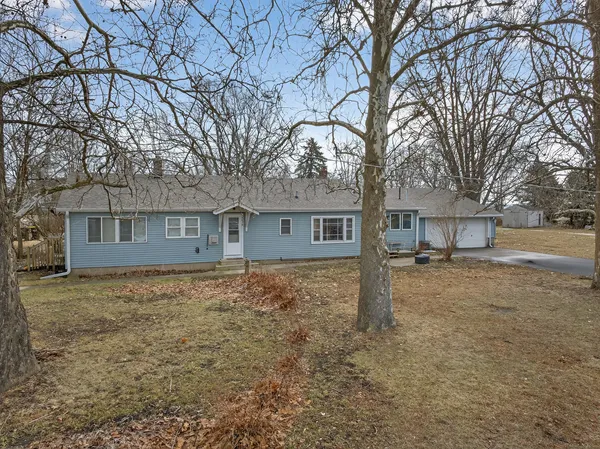 a view of a house with a yard covered in snow