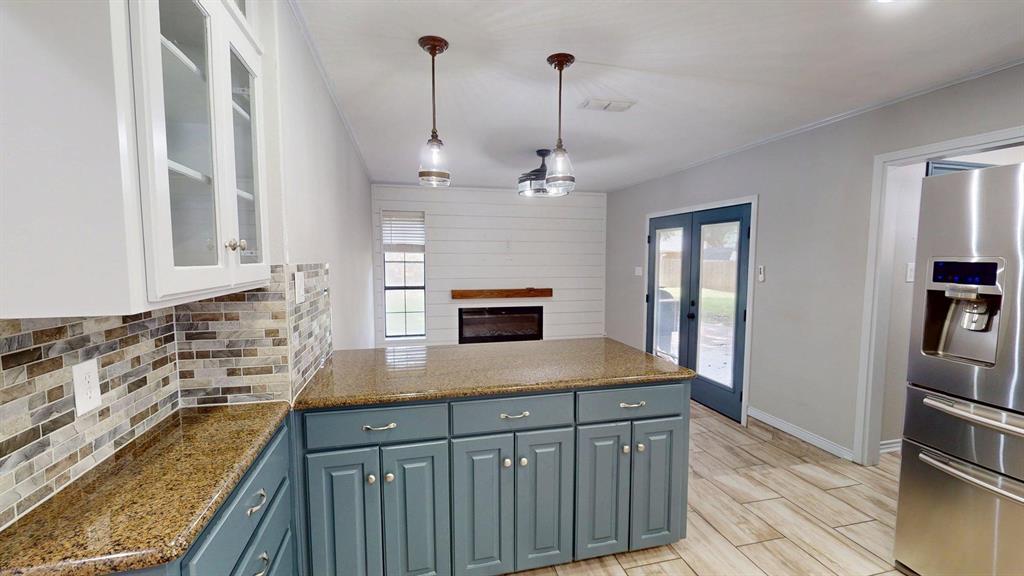 908 Rolling Drive Athens, TX 75751 - Photo 6 of 31 a kitchen with kitchen island granite countertop stainless steel appliances a sink stove and cabinets