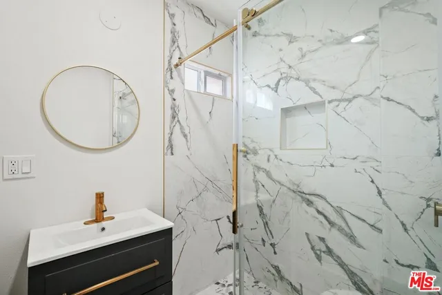 a bathroom with a sink vanity and a mirror
