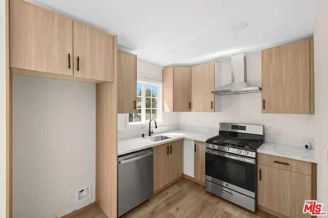 a kitchen with stainless steel appliances white cabinets and a sink