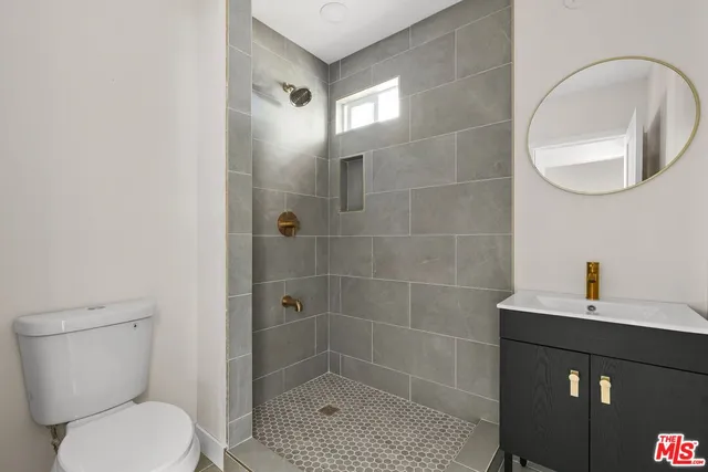 a bathroom with a toilet a sink and shower