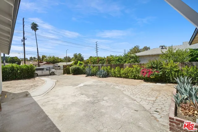 a pathway of a building with a yard