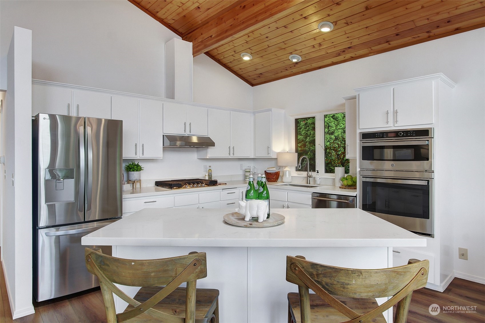 4824 Seahurst Avenue Everett, WA 98203 - Photo 15 of 33 a kitchen with refrigerator a stove a sink and chairs